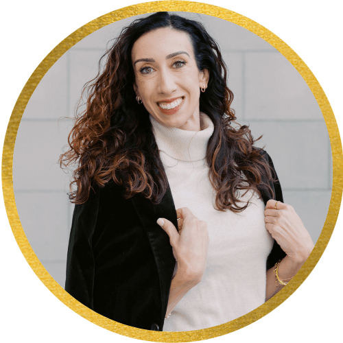 Woman smiling confidently in a professional headshot with gold circular frame