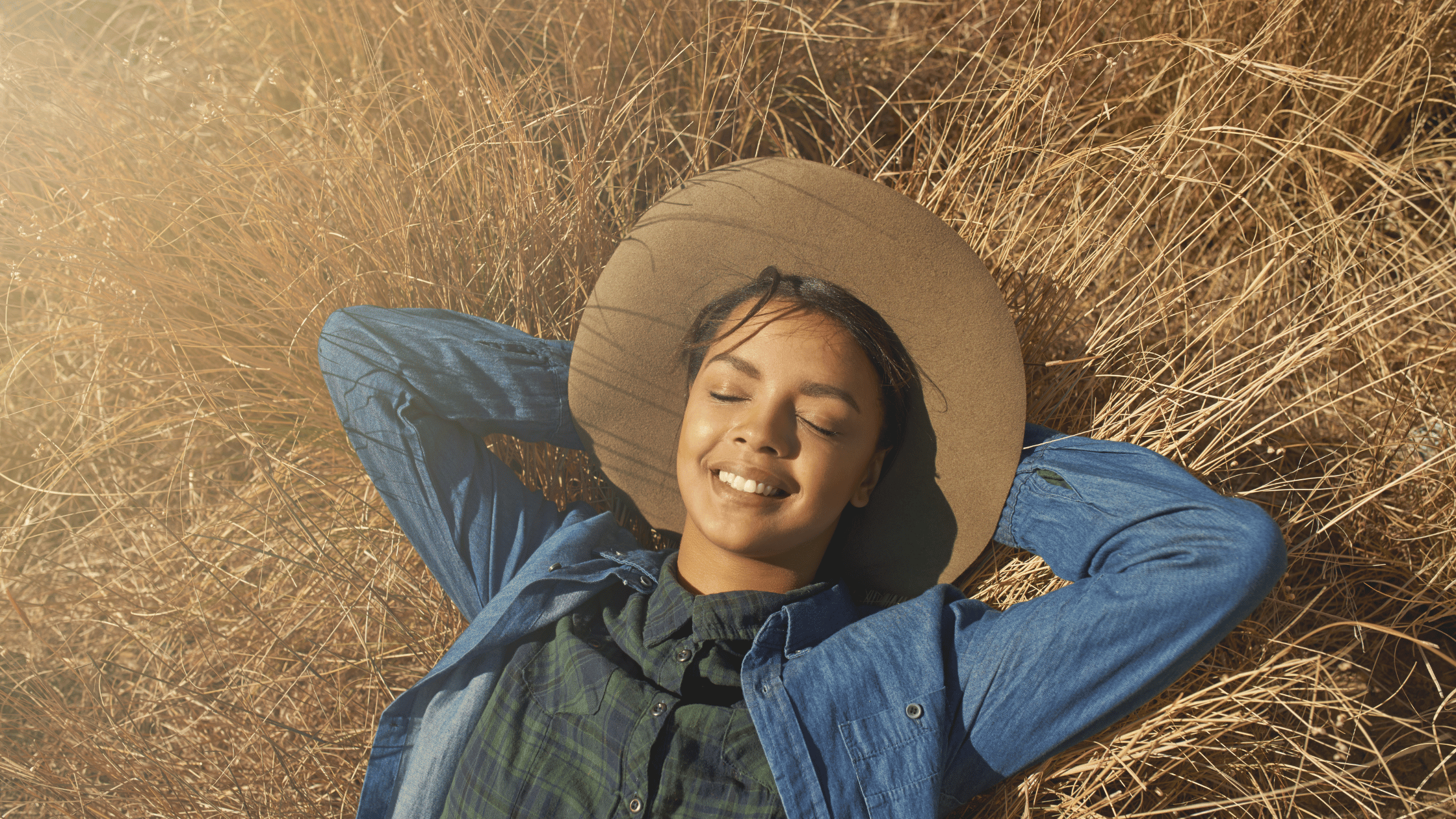 Blog Banner (3) A woman laying down on a field